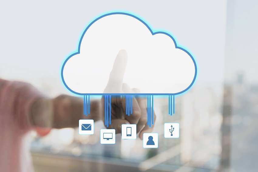 A hand touching a glowing cloud icon on a glass screen, with lines running down to mail, monitor, phone and user icons