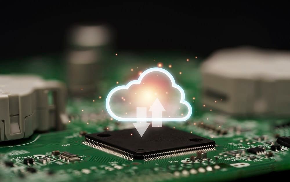 A glowing cloud icon with up and down arrows hovering over a processor chip on a green circuit board