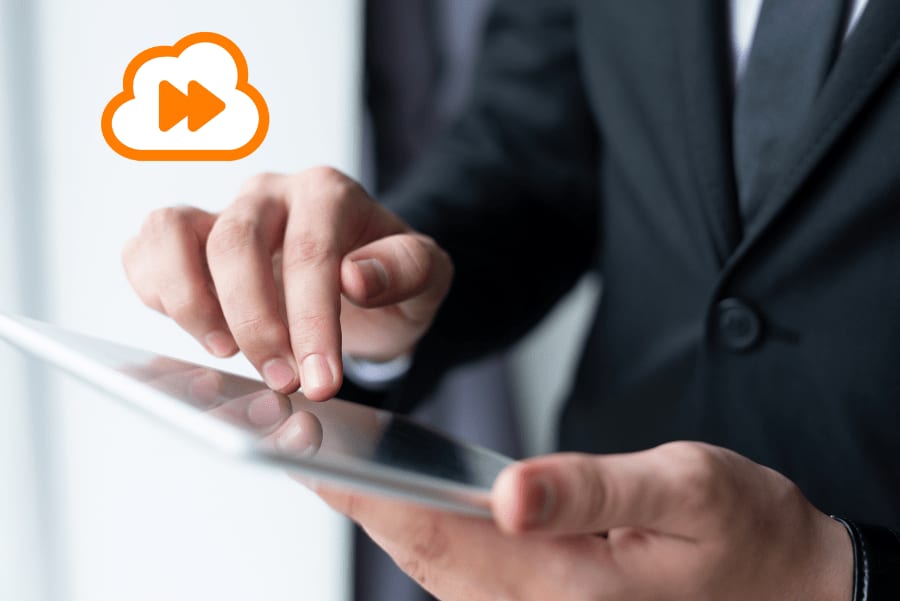 A person in a suit tapping a tablet, with an orange cloud-and-fast-forward icon beside their hand